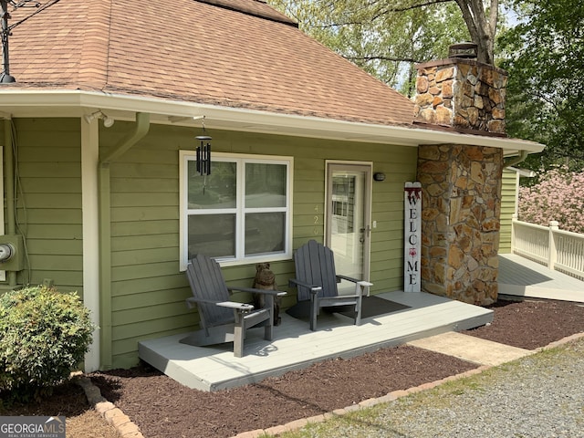 426 Shenendoa Dr, Ellijay, GA 30540 - back of house featuring a chimney, covered porch, and roof with shingles
