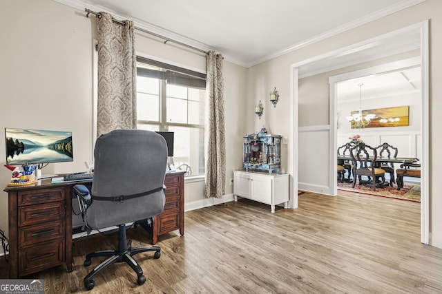 office space featuring crown molding, a chandelier, and light wood-type flooring