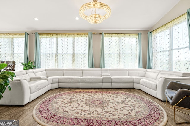 living area featuring vaulted ceiling, a notable chandelier, and recessed lighting