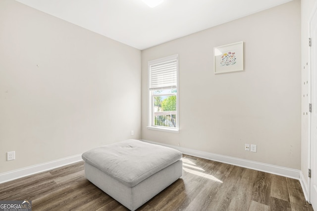 bedroom with wood finished floors, visible vents, and baseboards