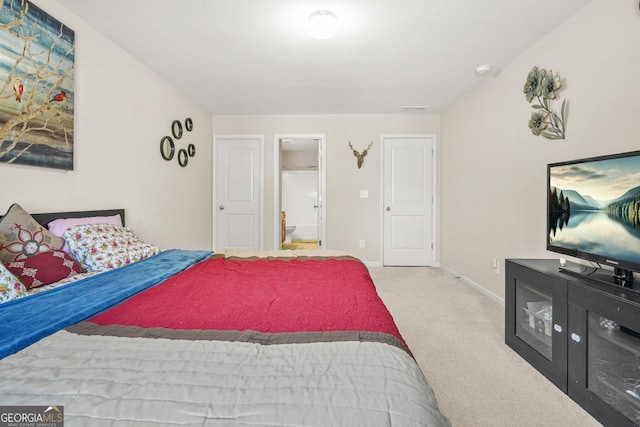 carpeted bedroom featuring visible vents and baseboards