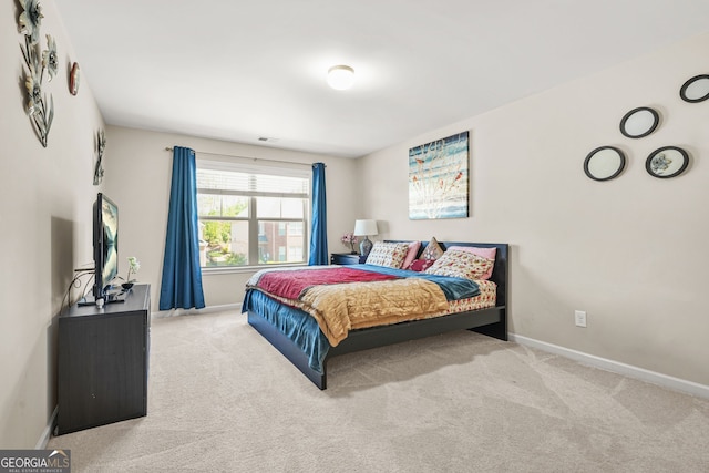 carpeted bedroom with visible vents and baseboards