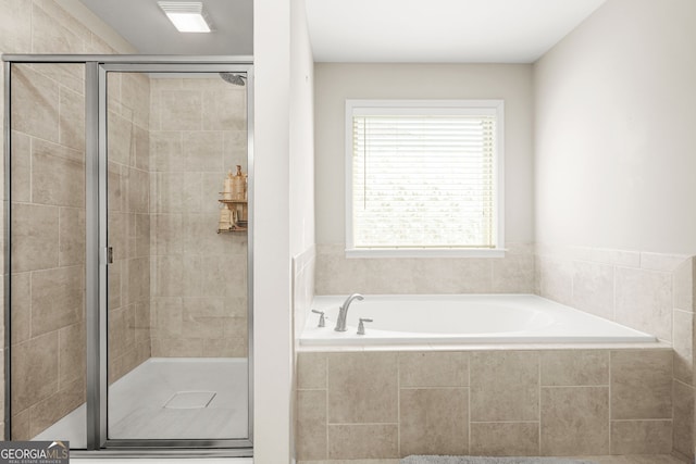 full bath featuring a garden tub and a stall shower