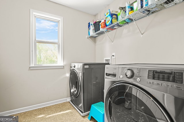 laundry room with washer and clothes dryer, baseboards, and laundry area