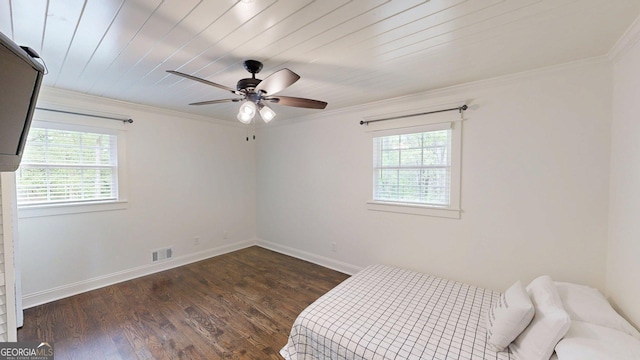 unfurnished bedroom featuring wood finished floors, baseboards, crown molding, and a ceiling fan