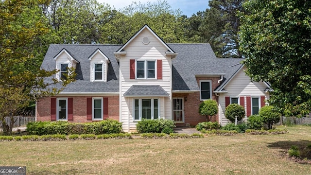250 Clearview Cir, Mcdonough, GA 30253 - view of front of house with fence, a shingled roof, a front lawn, and brick siding