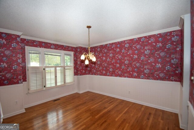 250 Clearview Cir, Mcdonough, GA 30253 - spare room with wainscoting, a chandelier, and wood finished floors