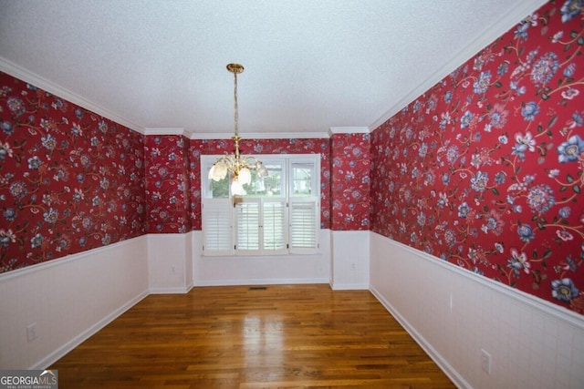 250 Clearview Cir, Mcdonough, GA 30253 - unfurnished dining area featuring wainscoting, wood finished floors, a notable chandelier, and ornamental molding