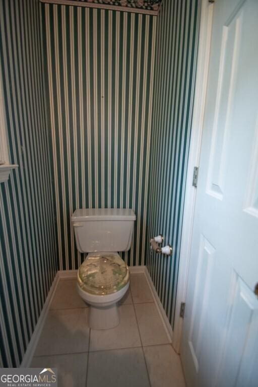 250 Clearview Cir, Mcdonough, GA 30253 - bathroom with wallpapered walls, tile patterned floors, baseboards, and toilet