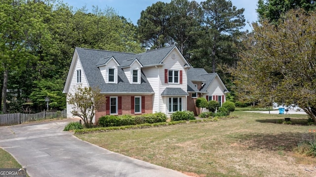 250 Clearview Cir, Mcdonough, GA 30253 - view of front of house featuring concrete driveway, a shingled roof, fence, a front yard, and brick siding