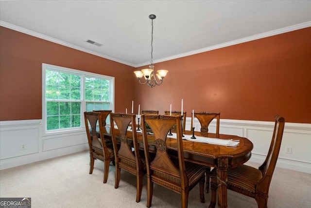 60 Heritage Keep, Covington, GA 30016 - dining room featuring a chandelier, light colored carpet, crown molding, wainscoting, and a decorative wall