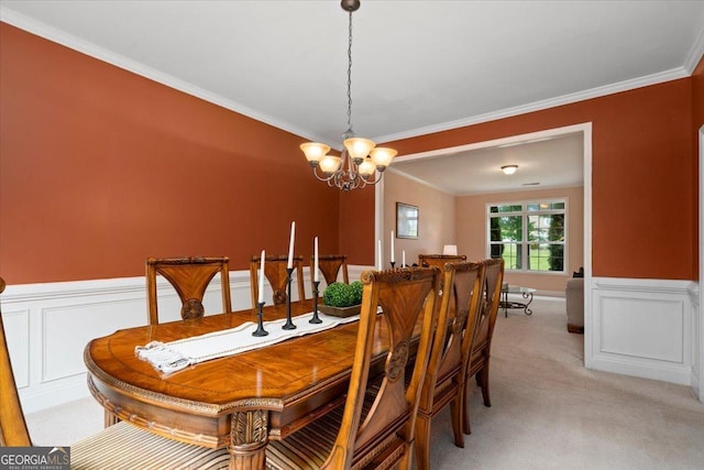 60 Heritage Keep, Covington, GA 30016 - dining area featuring a chandelier, wainscoting, light colored carpet, crown molding, and a decorative wall