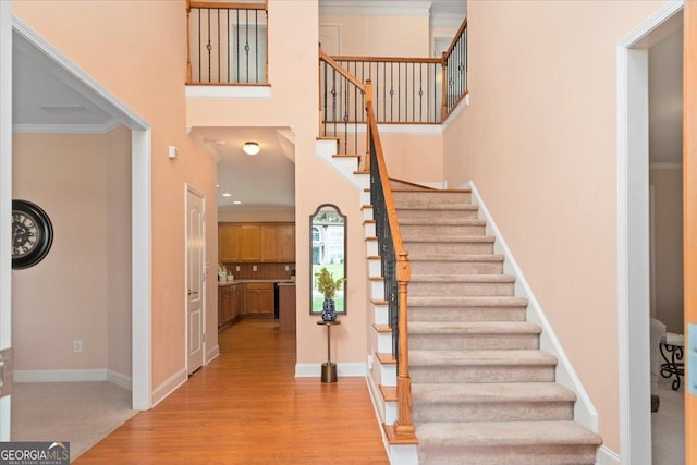 60 Heritage Keep, Covington, GA 30016 - entrance foyer featuring stairway, wood finished floors, a towering ceiling, and crown molding