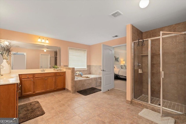 60 Heritage Keep, Covington, GA 30016 - full bathroom featuring vanity, a shower stall, a garden tub, tile patterned flooring, and ensuite bathroom