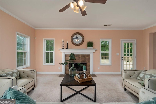 60 Heritage Keep, Covington, GA 30016 - living area featuring crown molding, carpet, ceiling fan, a fireplace, and healthy amount of natural light