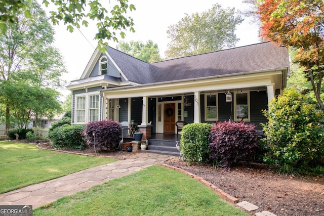 view of front of property with covered porch and a front yard