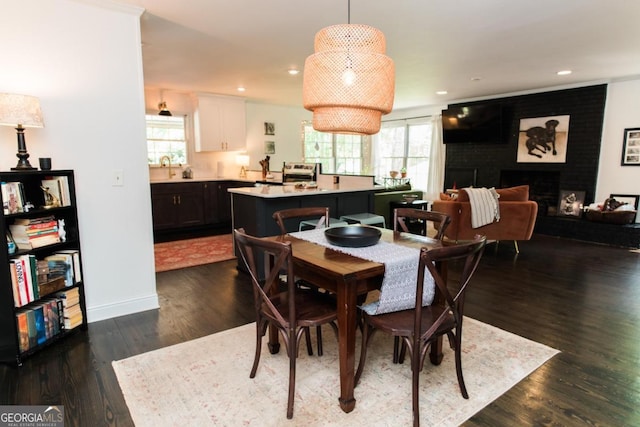 dining area with healthy amount of natural light, dark wood-style floors, recessed lighting, and baseboards