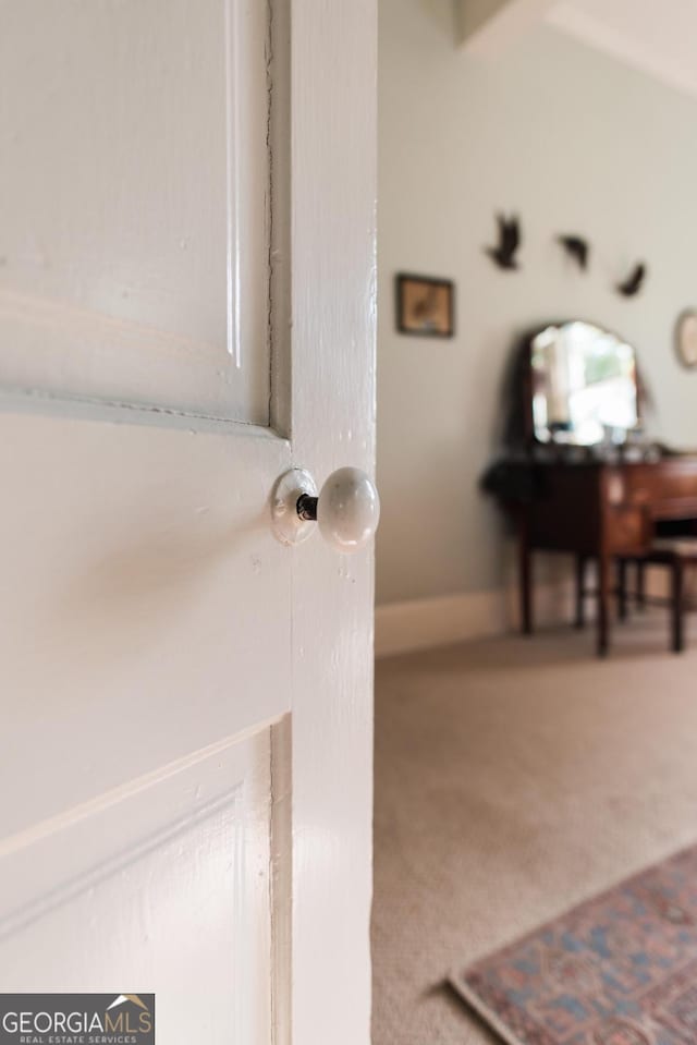 detailed view of carpet floors and baseboards