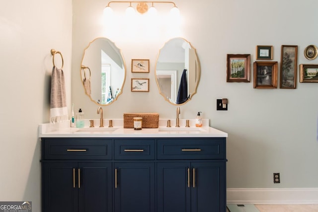 bathroom featuring double vanity and baseboards