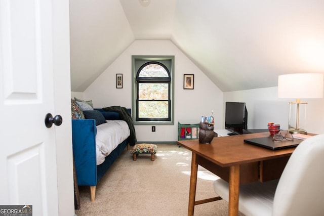 carpeted bedroom with lofted ceiling and an office area