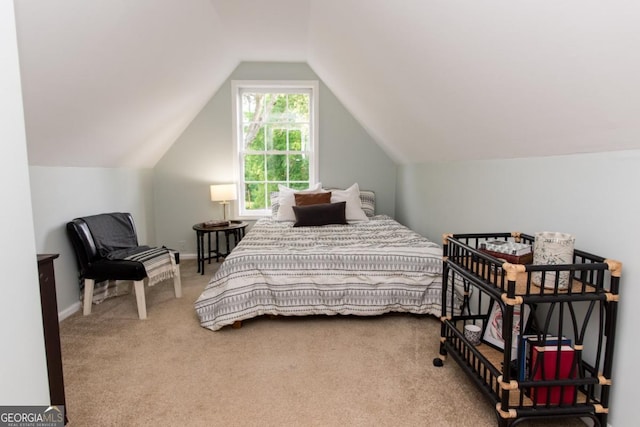 bedroom with carpet flooring, vaulted ceiling, and baseboards
