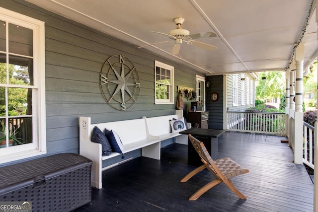 deck featuring covered porch and ceiling fan