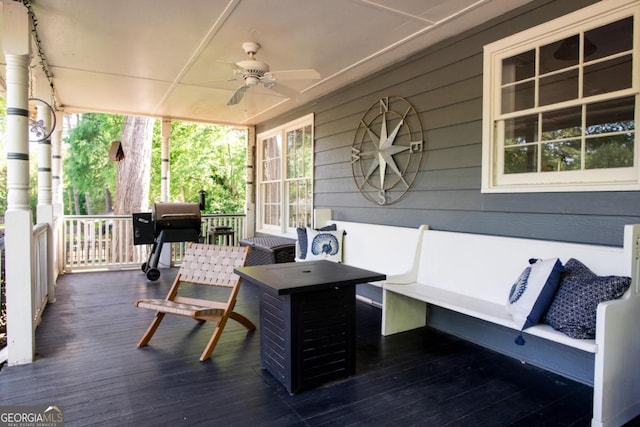 wooden terrace featuring ceiling fan