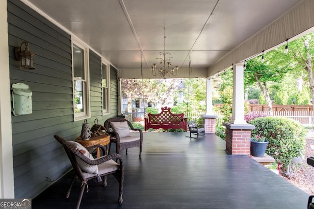 deck featuring covered porch and fence