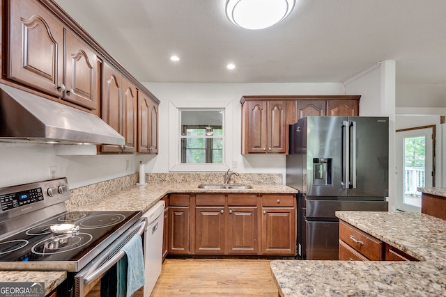 3990 Admiral Dr, Chamblee, GA 30341 - kitchen featuring stainless steel appliances, under cabinet range hood, a sink, light wood-style flooring, and light stone counters
