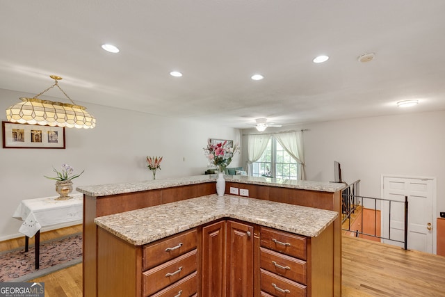 3990 Admiral Dr, Chamblee, GA 30341 - kitchen featuring light wood-type flooring, a kitchen island, ceiling fan, brown cabinetry, and recessed lighting