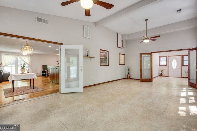 tiled foyer entrance with a ceiling fan, beamed ceiling, high vaulted ceiling, and baseboards