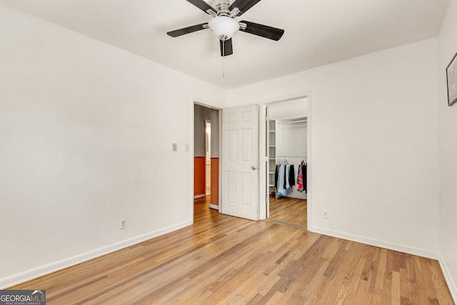 3990 Admiral Dr, Chamblee, GA 30341 - unfurnished bedroom with baseboards, light wood-type flooring, a closet, a walk in closet, and ceiling fan