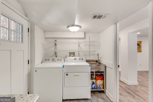 3990 Admiral Dr, Chamblee, GA 30341 - laundry room with washer and clothes dryer, light wood finished floors, and baseboards