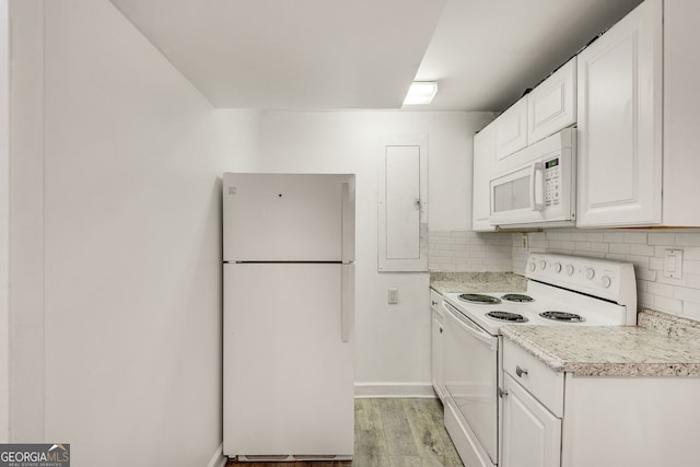 kitchen featuring white appliances, light wood-type flooring, white cabinetry, decorative backsplash, and baseboards
