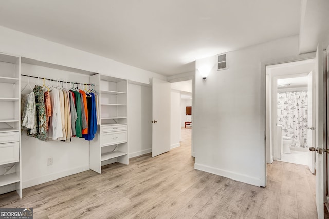 unfurnished bedroom featuring light wood-style floors and baseboards