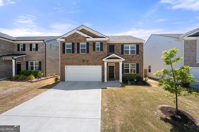 traditional-style home featuring an attached garage, a front lawn, driveway, and brick siding