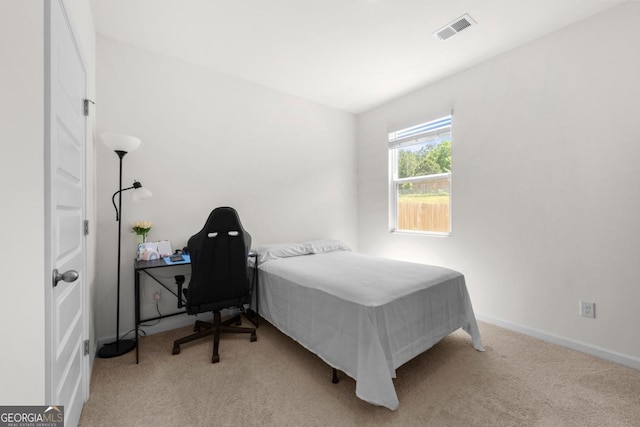 carpeted bedroom featuring baseboards and visible vents