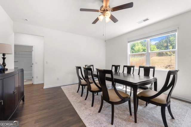 dining room with a ceiling fan, baseboards, dark wood-style flooring, and visible vents