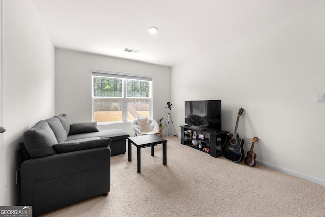 living area featuring baseboards, visible vents, and light colored carpet