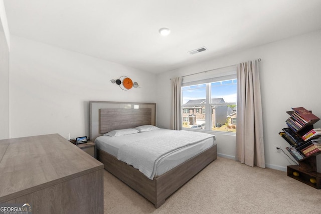 bedroom with light carpet, baseboards, and visible vents
