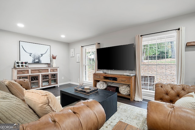 living room featuring baseboards, recessed lighting, and dark wood finished floors