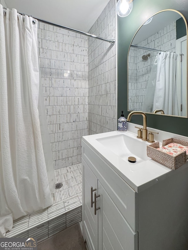 bathroom with vanity, tile patterned floors, and tiled shower