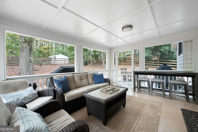 sunroom featuring outdoor dry bar, an outdoor hangout area, and coffered ceiling
