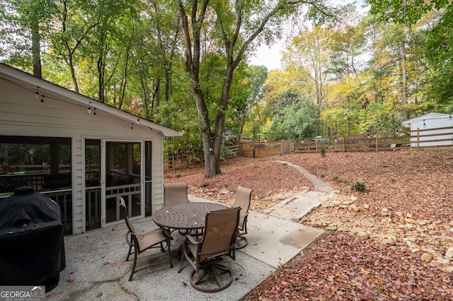 view of patio / terrace with a fenced backyard, outdoor dining area, and a grill