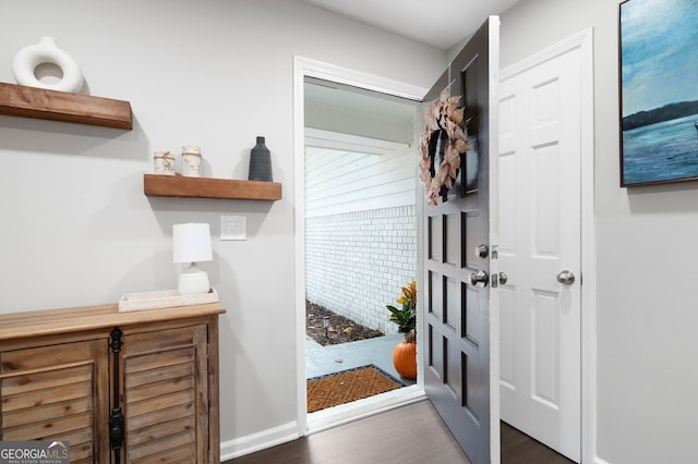 mudroom featuring wood finished floors and baseboards
