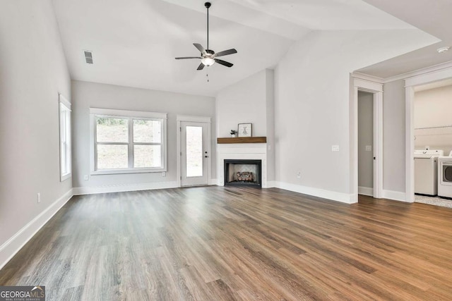 205 Farrell Creek Dr, Senoia, GA 30276 - unfurnished living room featuring separate washer and dryer, vaulted ceiling, a ceiling fan, dark wood finished floors, and a fireplace
