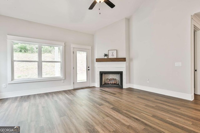 205 Farrell Creek Dr, Senoia, GA 30276 - unfurnished living room with vaulted ceiling, a ceiling fan, a fireplace, and dark wood-type flooring