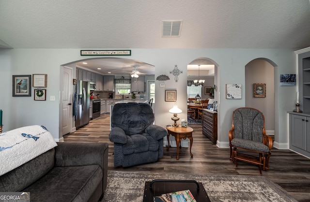 99 Mcmillian Ct, Winder, GA 30680 - living area featuring arched walkways, wood finished floors, and visible vents