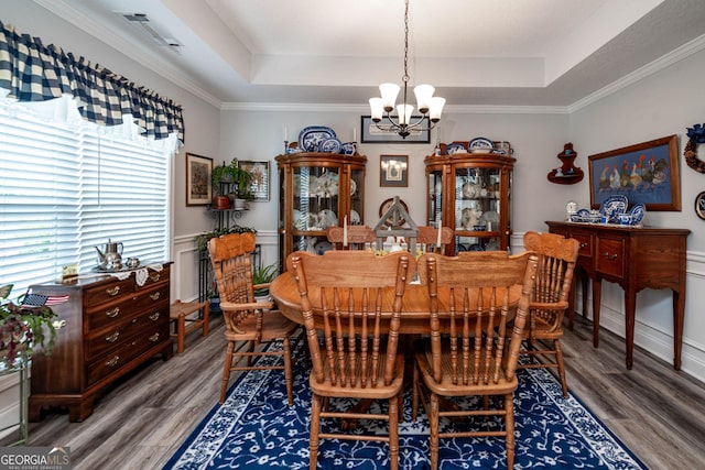 99 Mcmillian Ct, Winder, GA 30680 - dining room with wood finished floors, a tray ceiling, and an inviting chandelier