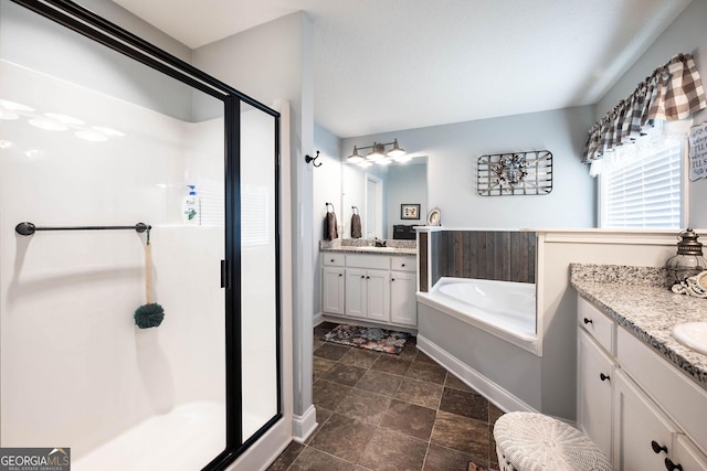 99 Mcmillian Ct, Winder, GA 30680 - full bath featuring a garden tub, a sink, a stall shower, baseboards, and two vanities